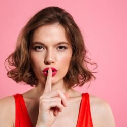 close-up-portrait-attractive-brunette-woman-showing-silence-gesture_171337-10106